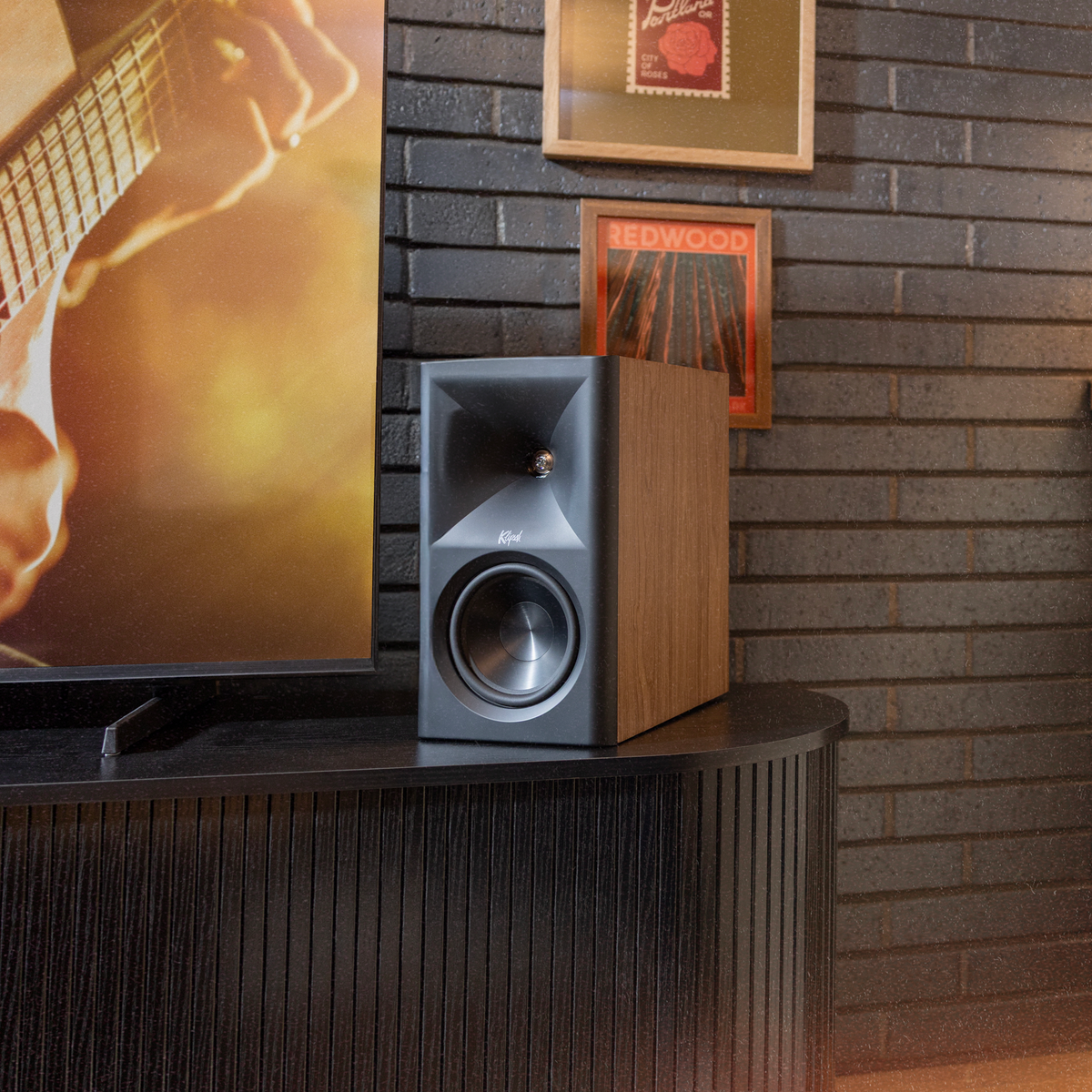 Klipsch The Fives II Walnut Klipsch The Fives WN in loft beside tv on modern media console with Americana art on wall behind 2000x2000