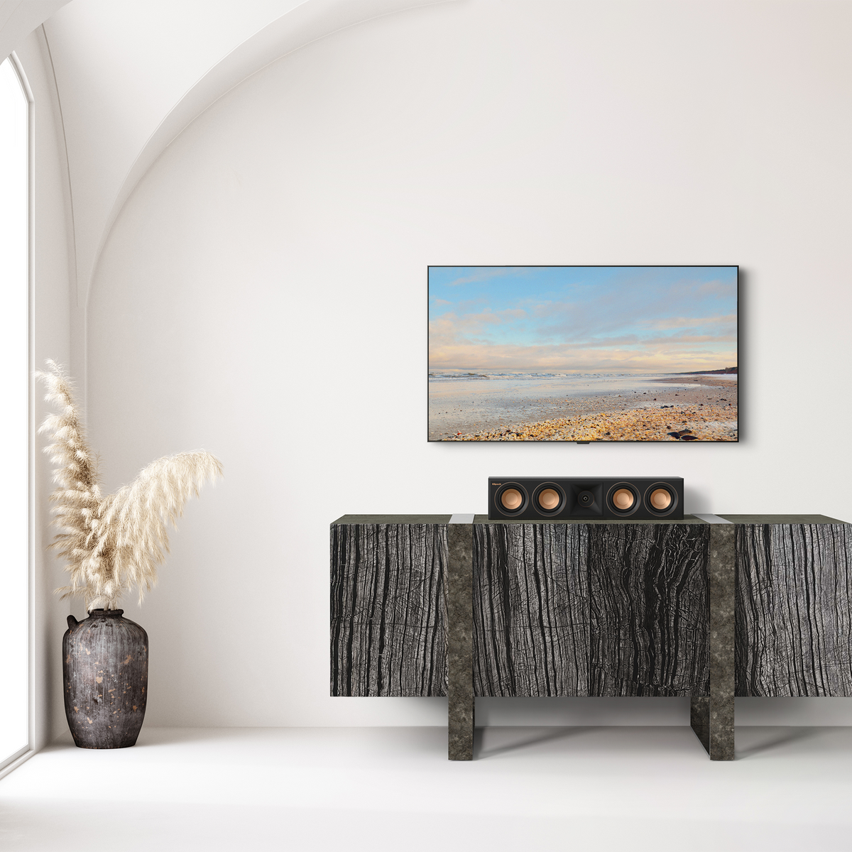Klipsch RP-404C II Ebony RP 404C II sitting on a credenza under a TV with its grille off