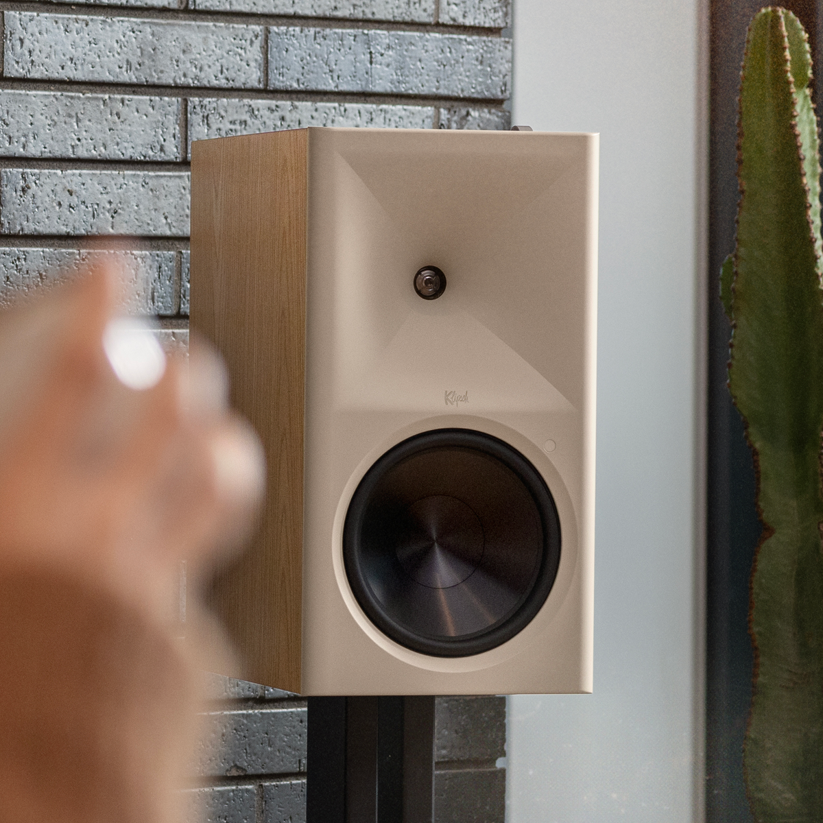 Klipsch The Nines II Red Oak Klipsch The Nines RO on Klipsch bookshelf speaker stands beside cactus against brick feature wall 2000x2000