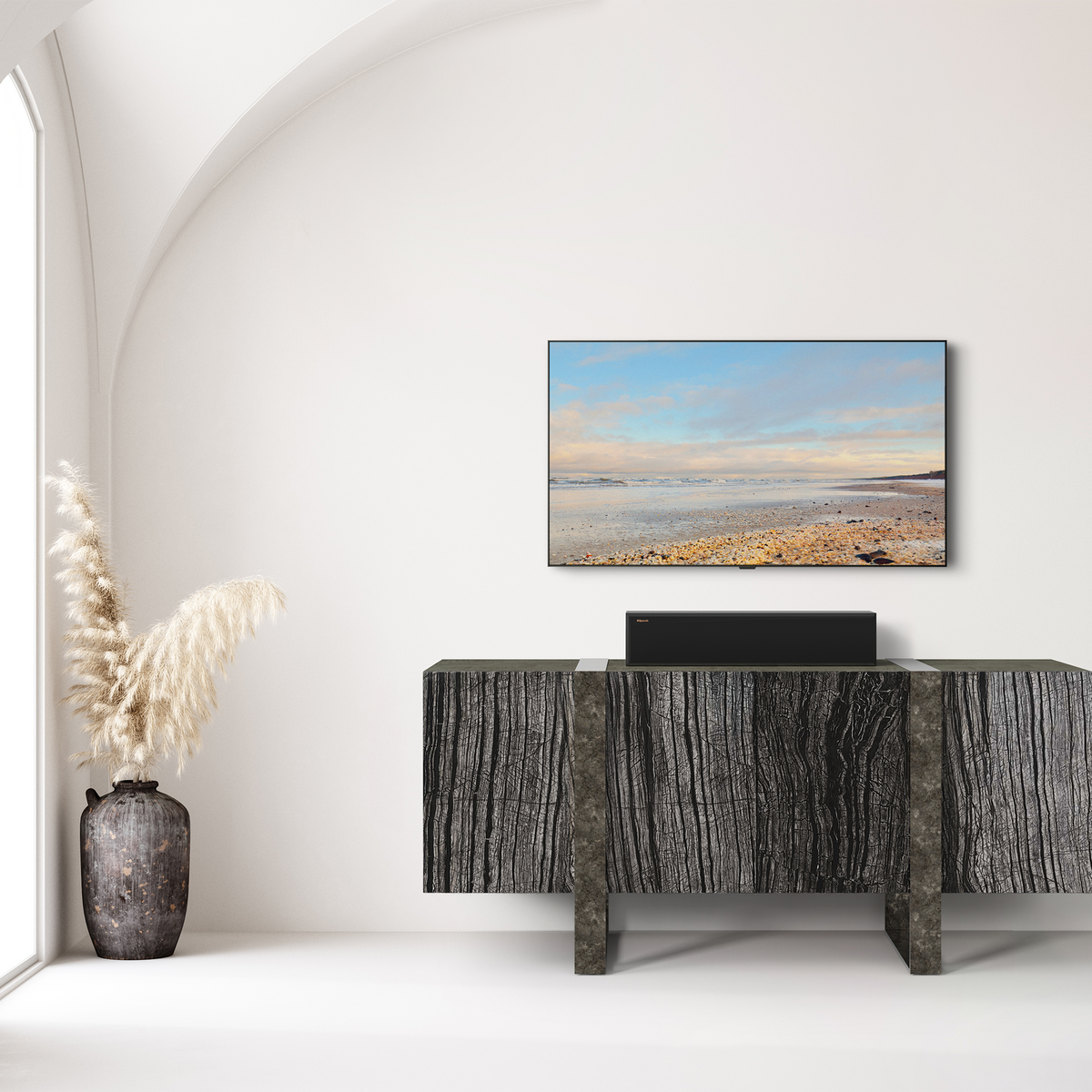 Klipsch RP-404C II Ebony RP 404C II sitting on a credenza under a TV with its grille on